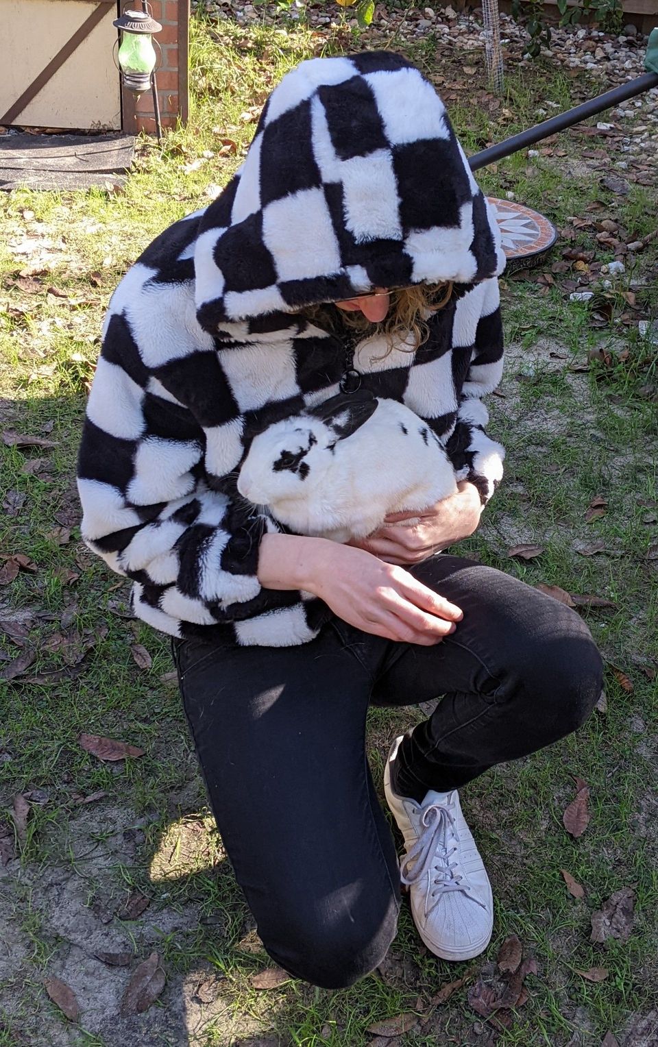 daphnis wearing a black and white jacket and holding a black and white bunny