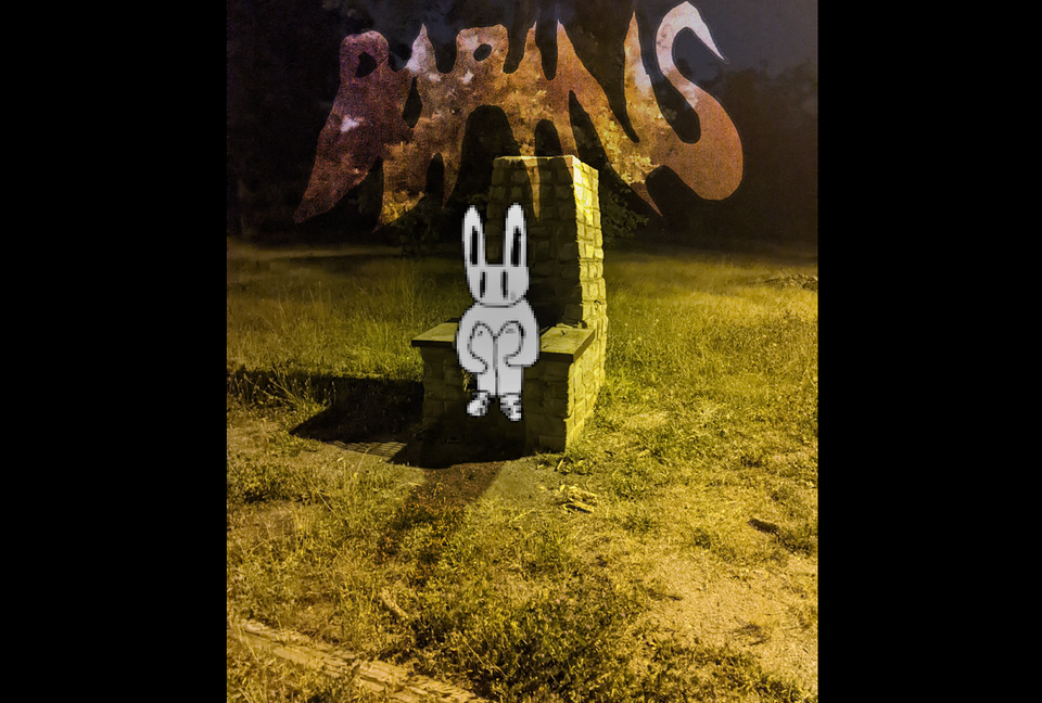 a bunny holding their knees sitting on a strange stone object that looks like a chair. it's night illuminated by yellow light