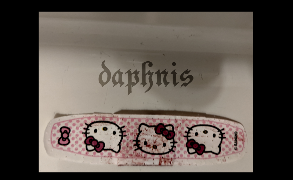 a sanrio hello kitty bandaid with blood spattered on hello kitty. it says daphnis.
