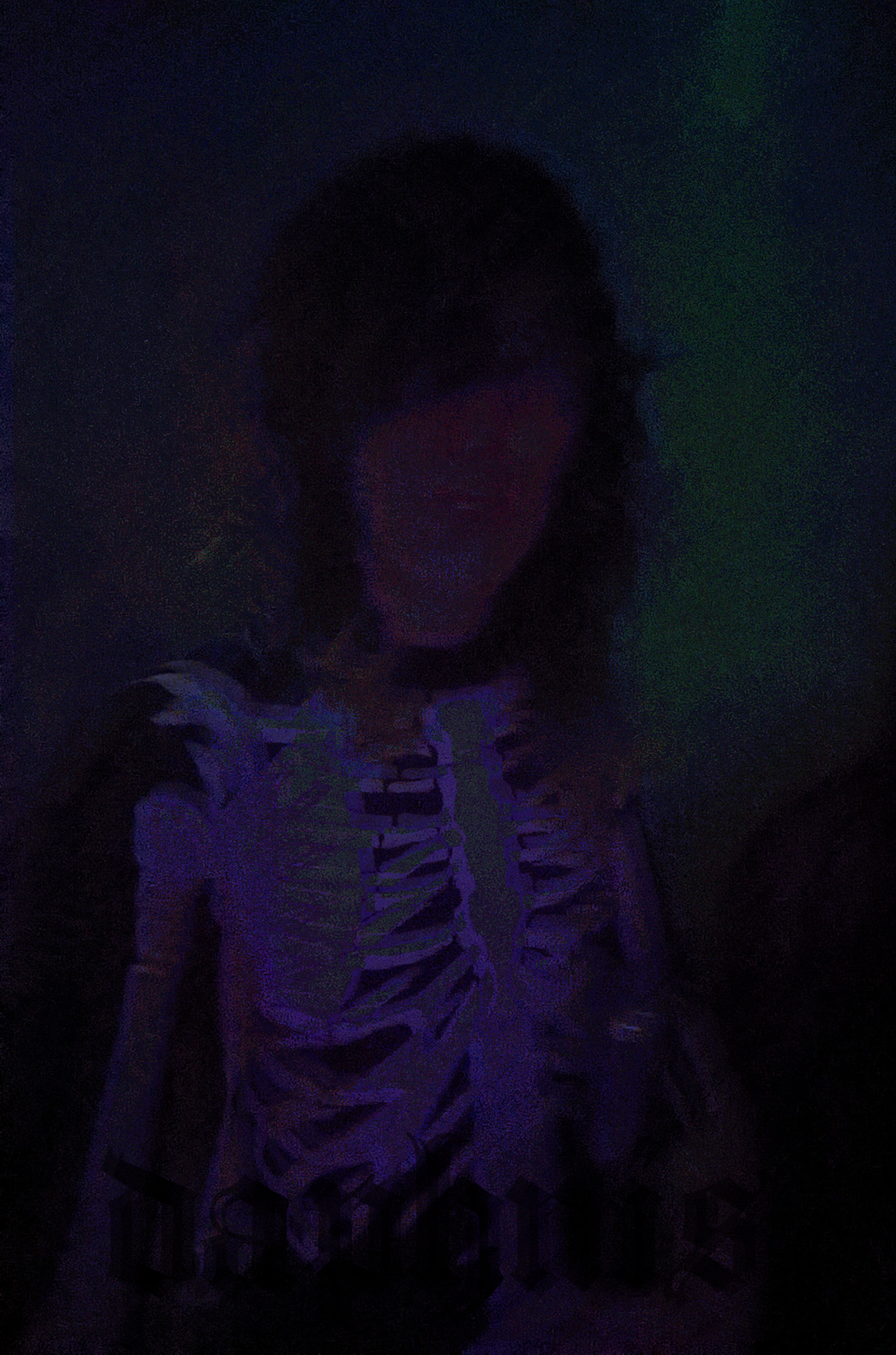 photo of daphnis at a rave that's fuzzy like a broken lcd monitor. she's wearing a skeleton jumpsuit.
